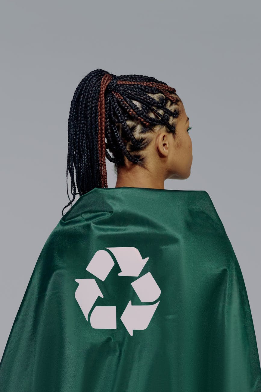 a back view of a woman in green cape