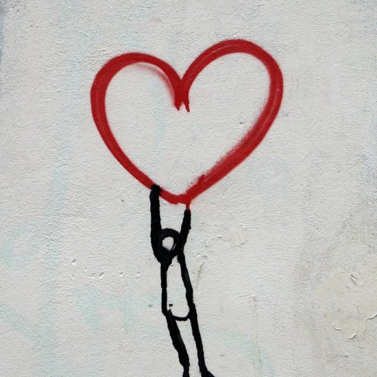 Photo by Nick Fewings red heart and man hanging drawing